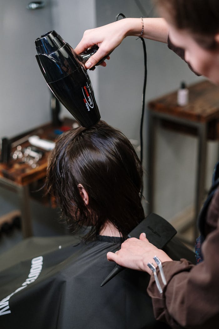 Services Hair stylist blow-drying a client